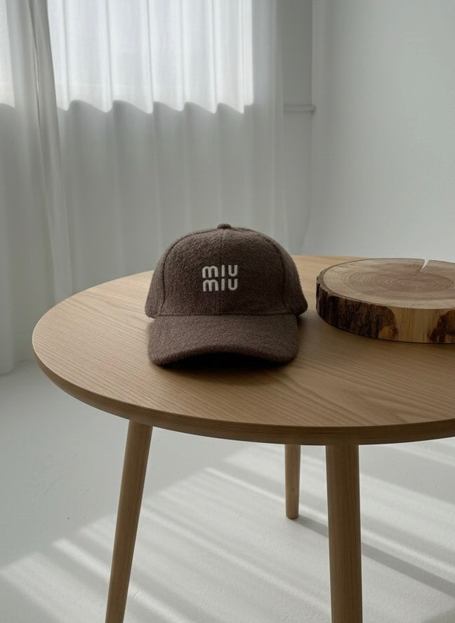 “MIU MIU” dark brown textured cap.
