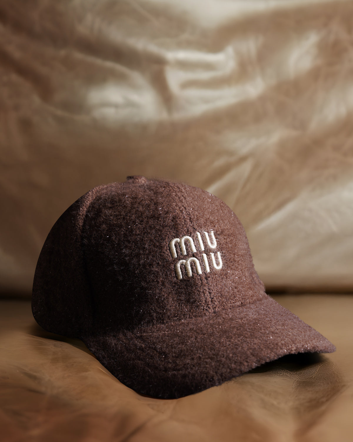 “MIU MIU” dark brown textured cap.