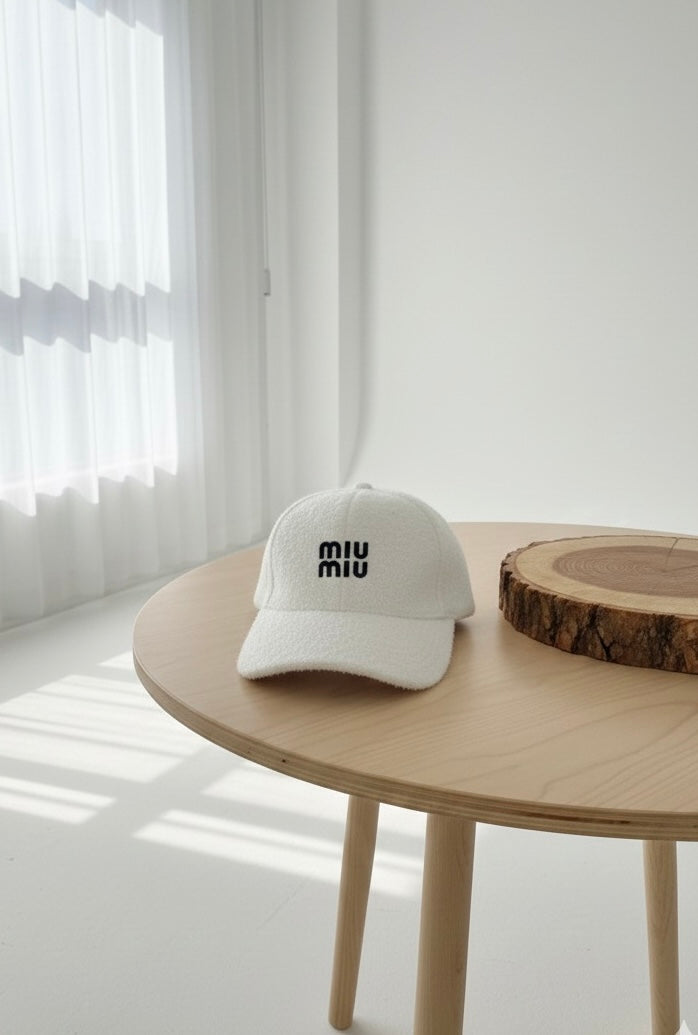 “MIU MIU” white textured cap.