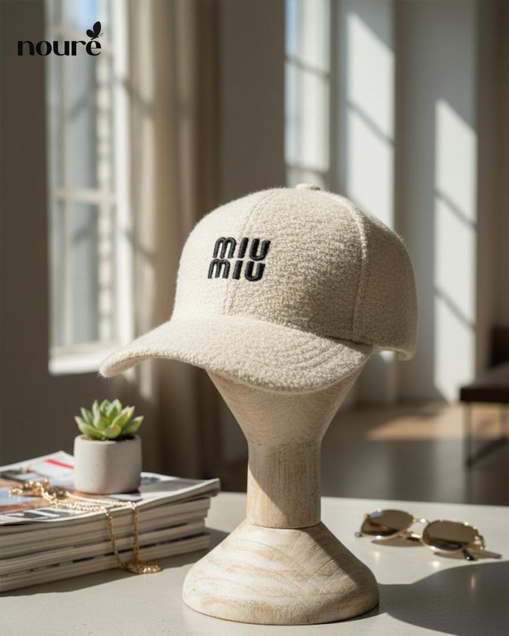 “MIU MIU” cream-colored textured cap.