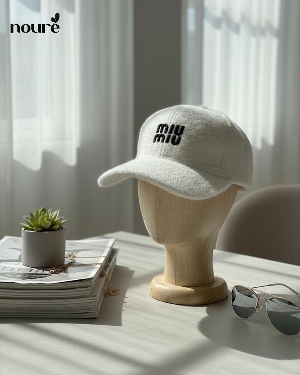“MIU MIU” white textured cap.